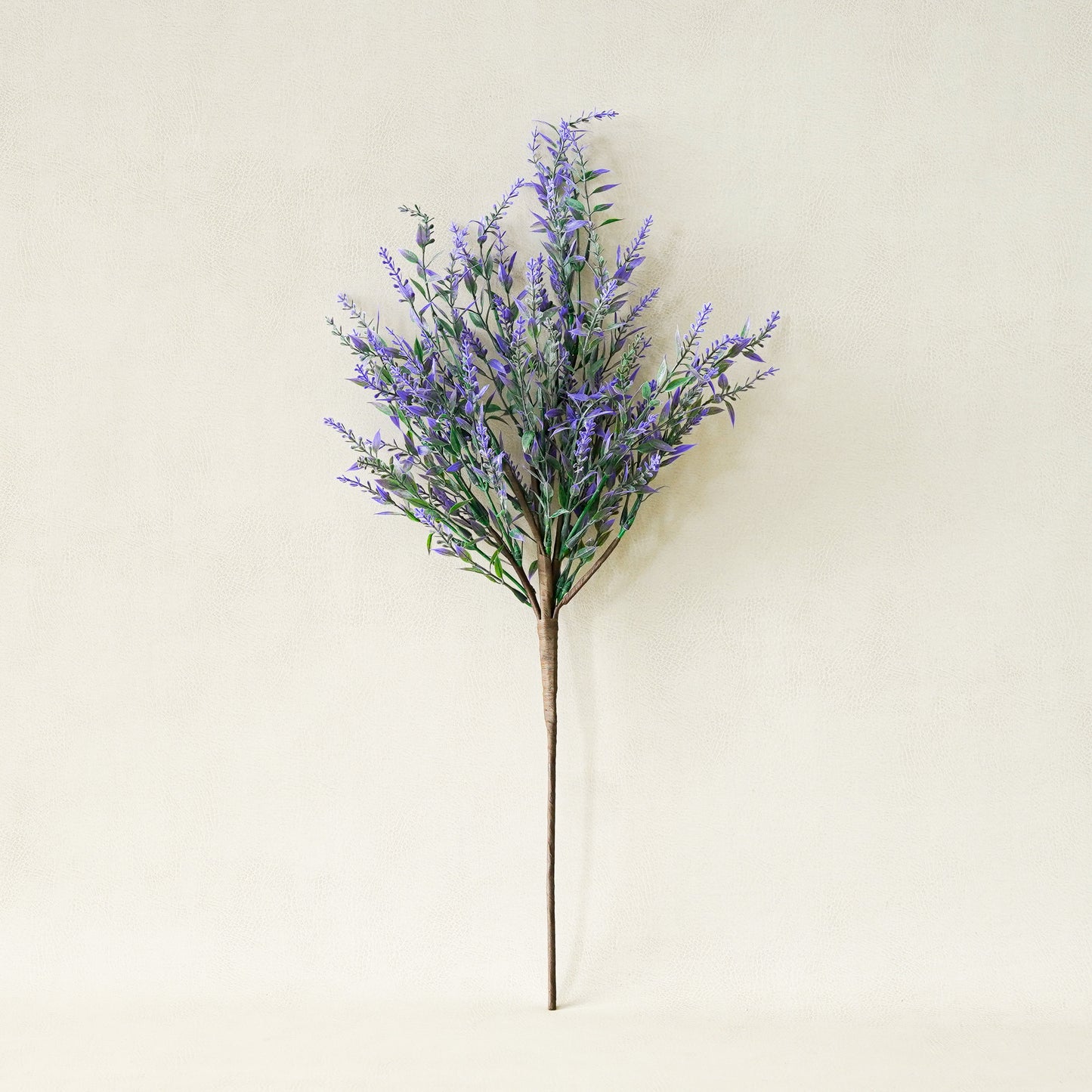 Artificial lavender plant on a beige background