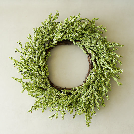 Green wreath on a plain wall