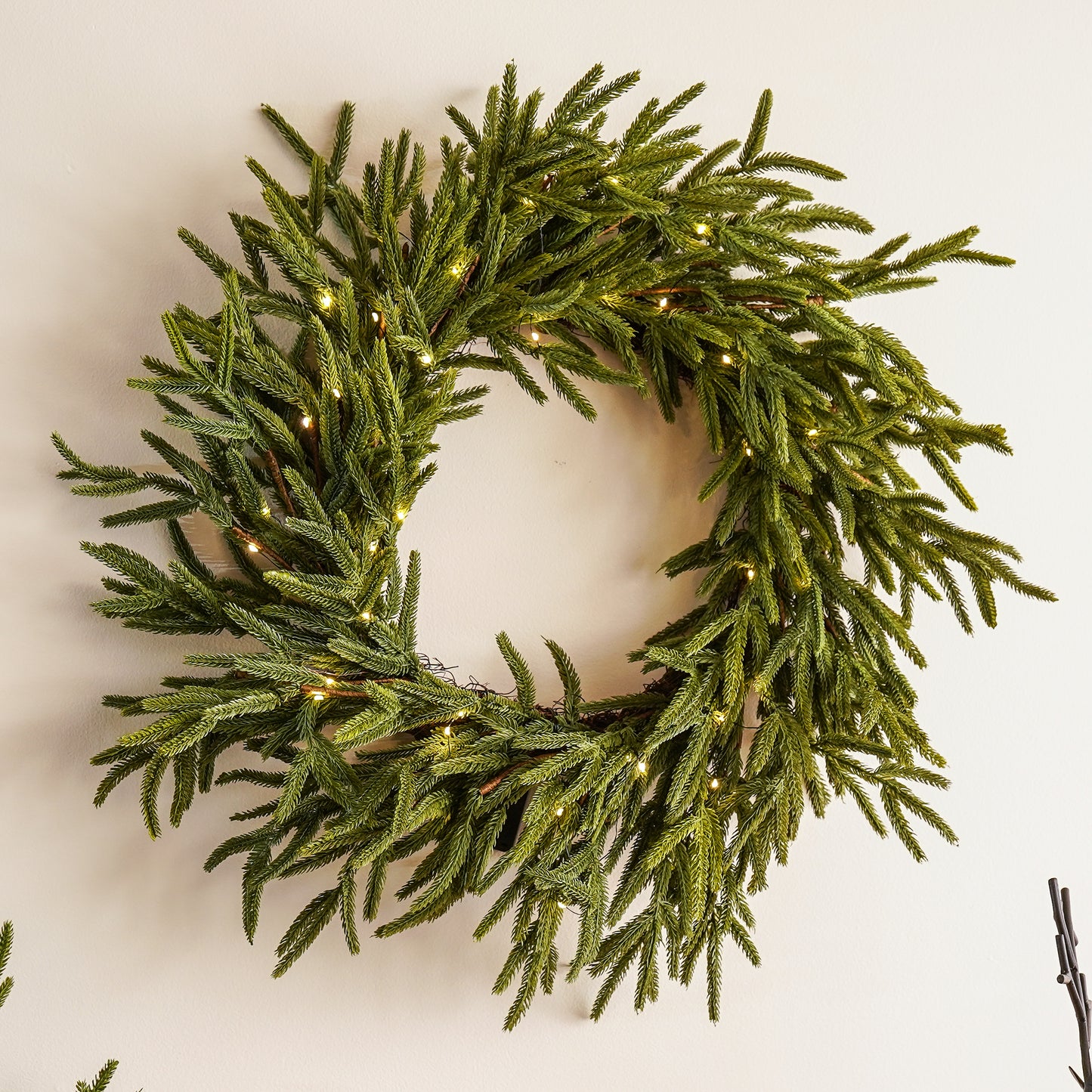 Green wreath with lights on a white background