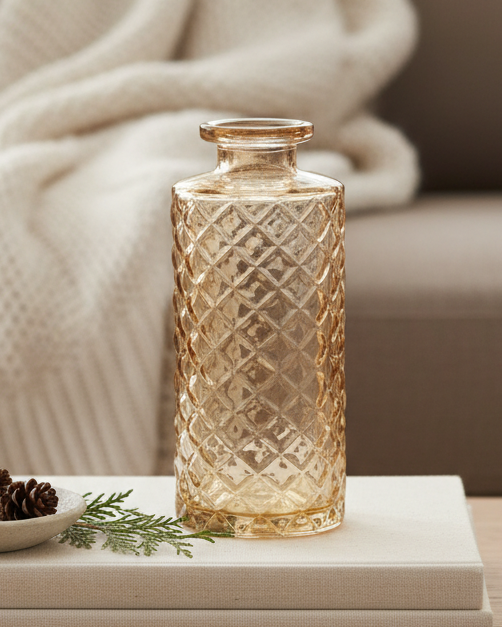 Decorative glass vase on a coffee table with a cozy living room background