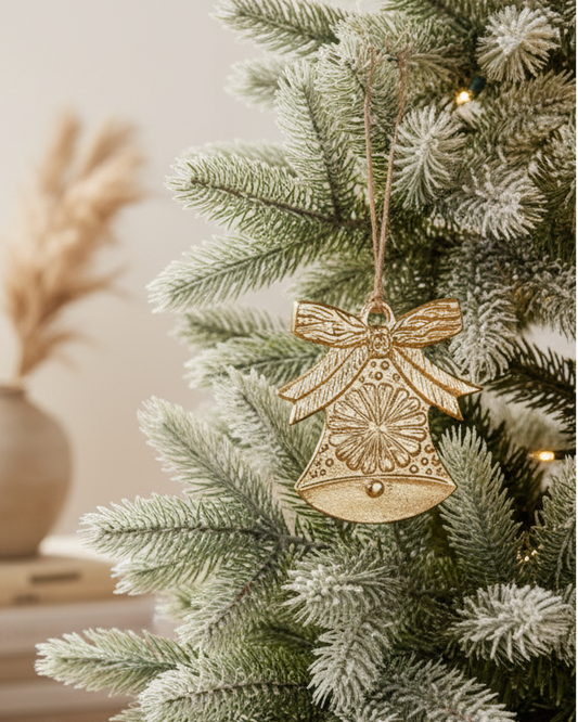 Decorative Christmas tree with a bell ornament in a cozy living room.