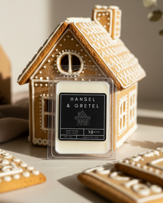 Gingerbread house-shaped candle with 'Hansel & Gretel' branding on a neutral background