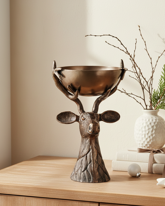 Decorative deer head bowl on a wooden surface with a neutral background
