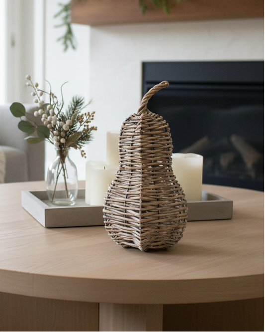 Living room with a round wooden coffee table, decorative items, and a fireplace.