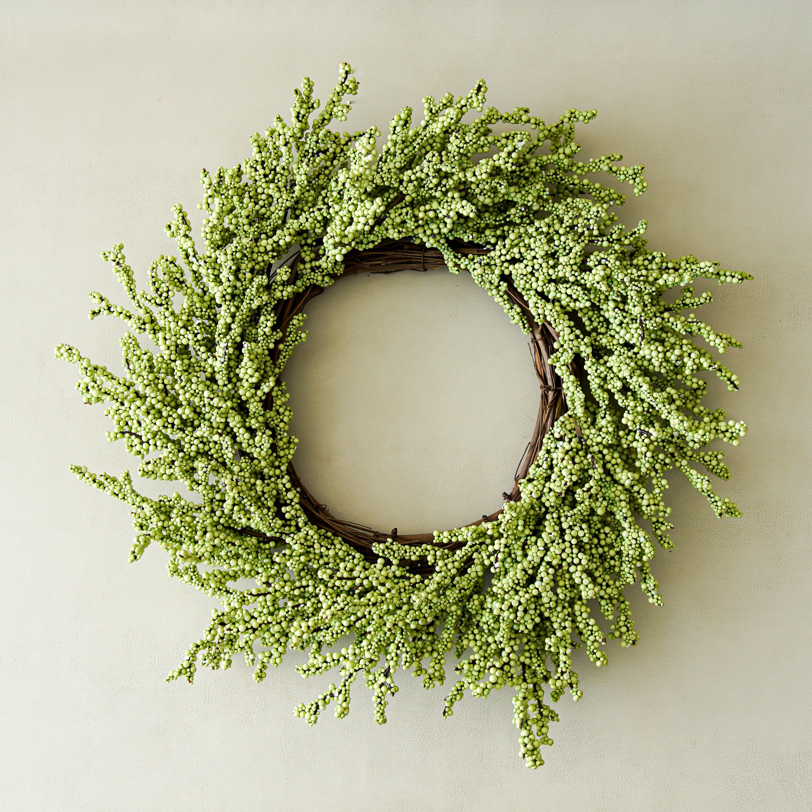 Green wreath on a plain wall