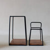 Two wooden stools with black metal frames on a white background
