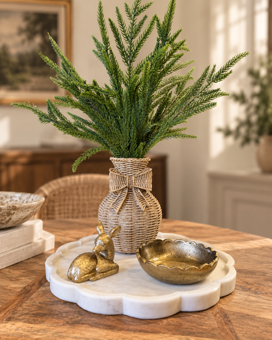 Woodland Heirloom styled arrangement featuring Norfolk pine greenery in woven bow vase, antique gold deer figurine, gold scalloped bowl and white marble tray